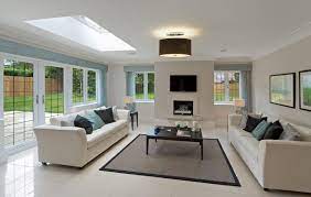 We love the gloomy hue of this minimalist living room and the twin skylights that totally illuminate the interior bringing natural sunlight in the place. 30 Naturally Lit Living Rooms With Skylights Pictures Skylight Living Room Ceiling Lights Living Room Living Room Flooring