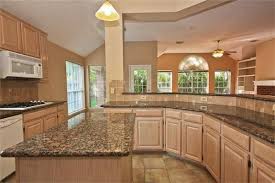 It is kept in its natural unvarnished finish to achieve a more rustic look. Sherwin Williams Functional Gray To De Pink Pickled Oak Cabinets Oak Kitchen Cabinets Oak Cabinets Oak Kitchen