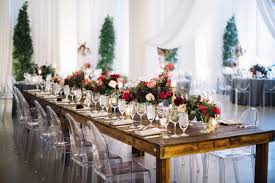 Rustic Wedding Reception With Wooden Tables Ghost Chairs Tall Fern Trees Clear Crysta Rustic Wedding Seating Rustic Wedding Reception Rustic Wedding Flowers