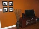 This bright orange hue is a fun way to freshen up the interior design of any space in your home. Burnt Orange Wall Behr Paint In Caramelized Orange For Dining Room Living Room Orange Burnt Orange Living Room Living Room Paint
