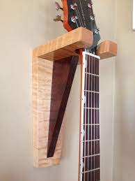 I wanted to get a guitar hanger for my guitars because it is good for the guiatrs and won't take up space. How To Build Your Own Guitar Hanger Diy Projects For Everyone