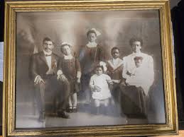 A moment with 26 year old South Lawrence shoemaker John Hickey (standing,  with unidentified man) in his Border Street workshop was captured