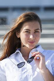 Close up portrait of beautiful young happy brunette woman with fresh skin, summer  street outdoors