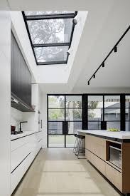 The skylight replacing the hatch was going to open while the other one would stay still. Open And Airy Kitchen With Large Skylights In A Rear Extension Of A Terrace House Melbourne Australia By Chan Architecture 1267x1900 Roomporn