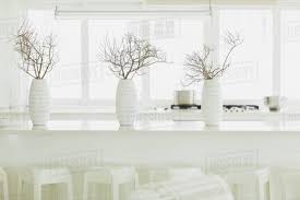 There are different kinds of floral vases that you can place for stylizing your dining tables such as glass, metal, or ceramic. Modern White Dining Table With White Vases And Branches Stock Photo Dissolve