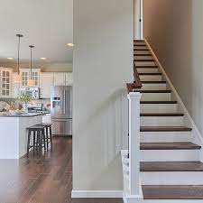 This Nottingham Model S Staircase Has A Stained Handrail And Stair Treads With Painted Risers Newel Post And Cap Board The Contra The Hamptons Mansions Home