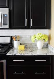 For larger tile cuts, set the tile in a tile cutter mesh side up, and score the face. How To Install A Subway Tile Kitchen Backsplash Young House Love