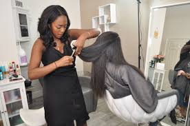 Young woman having hair washed in salon. Black Hair Salon Near Me Open Now Promotions