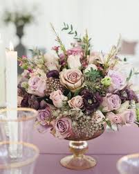 A Gorgeous Gold Glass Rose Bowl Arrangement Of Purple And Lavender Roses Lisianthus As Rose Gold Wedding Flowers Rose Gold Bouquet Purple Wedding Decorations