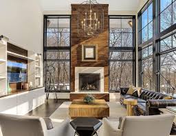 Living room design with modern brown fireplace. Modern Living Room Features Towering Fireplace Among Floor To Ceiling Windows Pella