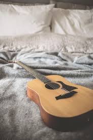 Room acoustics present one of the biggest challenges to recording acoustic guitar at home. Hd Wallpaper Brown Acoustic Guitar On Gray Blanket Bed Bedding Pillow Bokeh Wallpaper Flare