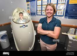 Carol Carr, health promotions coordinator with the 21st Medical Squadron,  right, and Staff Sgt. Brittany Rice, left, bioenvironmental engineering  technician with the 21st MDS, demonstrate how a Bod Pod is used at