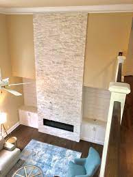 Power sofas, loveseat with console, power lift recliner Two Story White Stacked Stone Fireplace