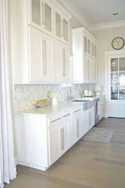 This elegantly designed kitchen uses classic white color scheme from the ceiling wood planks and beams, ceramic tile backsplash and inset style cabinetry blends well with the calacatta marble countertop. Are White Cabinets Going Out Of Style What Are More Common Kitchen T