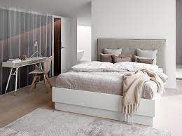 This is an example of a contemporary bedroom in melbourne with white walls, dark hardwood floors and brown floor. Modern Bedroom Furniture Sydney Beyond Furniture