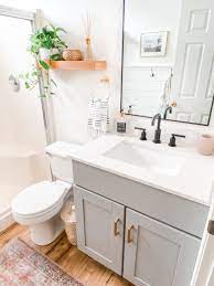 Plenty of budget bathroom ideas including adding a feature wood wall, updating an oak vanity, and painting a shower door frame. Small Bathroom Remodel Ideas Befor And After Domestic Blonde