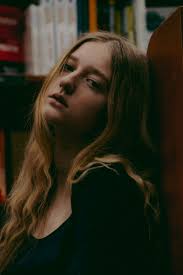 A woman covers her face with her hands photo