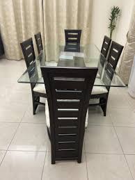 A glass top is easy to clean with a spray cleaner and simple wiping, which makes it perfect for a kitchen or dining room table that is always in contact with food, a kids play table or a coffee table. Black 6 Seater Wooden Dining Table With Glass Top Models And Price Decosouq