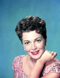 Image of Model Caron Gardner wearing a polka dot patterned swimsuit, July