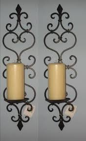 The frame has a burnished oil rubbed bronze finish. Tuscan Wrought Iron Fleur De Lis Candle Wall Sconce Set Candle Wall Decor Tuscan Wrought Iron Candle Wall Sconces