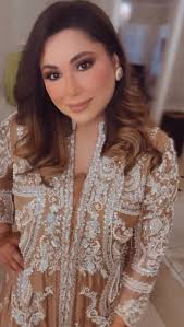 GISELE Flowy Ash pink chiffon top intricately hand embroidered with Pearls  , crystals with a cutwork hemline and feather edged sleeves complemented  with flared embroidered capris . Shop Now Available at Stores: .