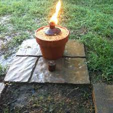 When Your Tiki Torches Are Old And Faded Make An Old Fashioned Smudge Pot Terra Cotta Pot Sand And The Old Oil Can Fr Diy Heater Terracotta Pots Tiki Bar
