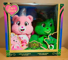 Brand New Set of Wicked Care Bear Plush Figures. Set contains collectible  silver sparkling figures of Love-A-Lot Bear as Glinda and Good Luck Bear as  Elphaba. Both figures are approximately 12 inches