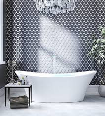 A traditional master bathroom has a modern feel with clean white subway tiles and herringbone mosaic. The Top Bathroom Tile Trends For 2021