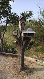 This Was A Tree Stump That My Sister Did Not Know What To Do With Decorated With Bird Houses It Makes An Interesting In 2020 Bird Houses Tree Stump Tree Stump Planter