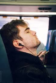 Sleeping Teen Wearing Earbuds Listens To Music On Commuter Train" by  Stocksy Contributor "Cara Dolan"
