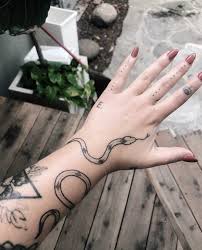 A flower tattoo with a snake symbolizes you have the desire to express your side of femininity. Big Wrapping Snake Tattoo By Robbie Ra Moore Tattoogrid Net
