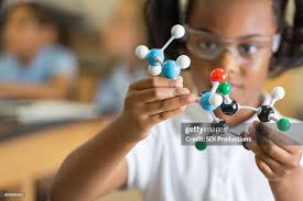 Elementary Science Student Using Plastic Atom Model Educational Toy High-Res  Stock Photo