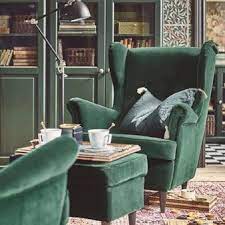 the unmistakable shape of a strandmon wing chair complete with a matching dark green footstool chos green chair living room ikea armchair living room chairs