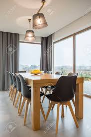 This simple dining room table by walker edison is just the thing for those with limited square footage. Modern Dining Room With Wooden Table And Big Windows Stock Photo Picture And Royalty Free Image Image 78950088