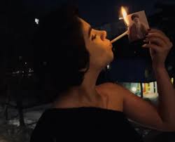 Iranian women light cigarettes with burning photo of their ...