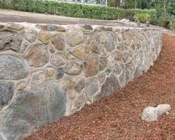 If water puddles or gathers inside your wall, drill a few small drain holes in the tires. Rock Retaining Wall With Grout Off The Rails Creative Landscaping
