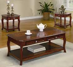 End tables have a lower shelf for expanded storage. Warm Brown Cherry Finish Traditional 3pc Coffee Table Set