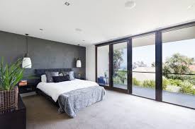 Bedroom interior with white bedding and hardwood floor. Customize Interior Glass Doors Glass Doctor