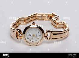 Old Quartz gold coloured ladies watch and metal linked strap Stock Photo -  Alamy
