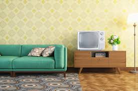 This rustic living room contains a comfortable vintage style lounge chair along with two types of sofas in shades of brown and beige. 6 Decorating Tips For Retro Style