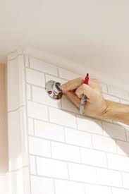 Existing shower curtain rod is screwed to one wall, and then elbows up and screwed to ceiling. How To Drill Into Tile To Hang A Shower Curtain Chris Loves Julia