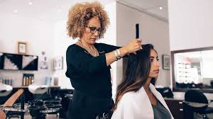 Beautiful model with long, dense, curly hair and vivid makeup with red lipstick. Hairdressing Insurance Simply Business Uk