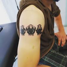 Dinosaur riding green bicycle tattoo on bicep. Top 97 Best Hear No Evil See No Evil Speak No Evil Tattoo Ideas