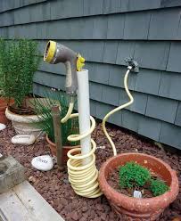 23 Creative Ways To Store Your Garden Hose Diy Garden Projects Garden Hose Storage Garden Projects