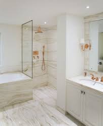 An elegant bathroom done with white marble tiles and a matching tile floor plus a marble bench in the shower space. An Interview With Katharine Pooley Luxury Interior Design Journal Marble Bathroom Designs Gold Bathroom Decor Bathrooms Remodel