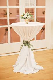 Cocktail Tables By Dance Floor Are Cinched And Tied With Eucalyptus Greenery A Gold Wedding Cocktail Table Decor Cocktail Table Decor Wedding Cocktail Tables