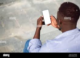 African American man holding smartphone with blank screen on stone staits  outside, mockup for mobile app design Stock Photo - Alamy