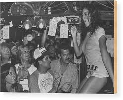 Traditionally, it has short sleeves and a round neckline, known as a crew neck, which lacks a collar. A Wet T Shirt Contest Wood Print By George Rose