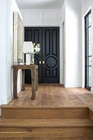 The paned glass front door pours natural light into the inviting foyer. 5 Reasons To Have Black Interior Doors In Your Home