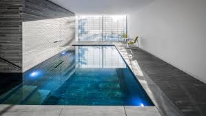 Stone Lined Swimming Pool In Cologne House Features Large Window With Garden Views Dezeen Indoor Pool Design Indoor Outdoor Pool Modern Pools